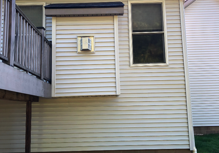 After image of the back side of a house with vinyl siding.