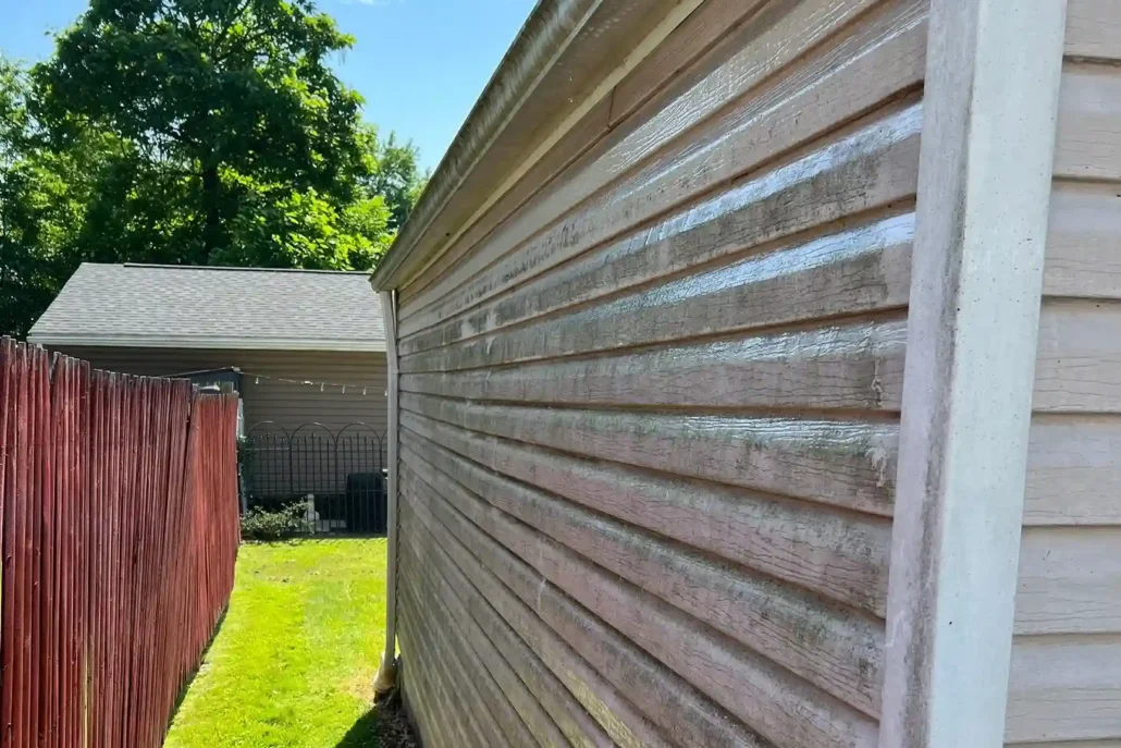A Garage in Columbiana Caked in Dirty, Mud, and Moss Before Being Pressure Washed.