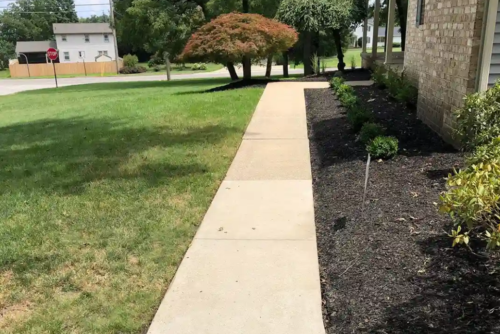 A Clean Sidewalk Shines in the Sun After Being Pressure Washed in Howland.