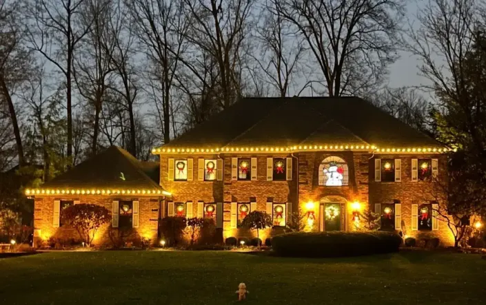 A Home in Poland Shines Bright in the Night with its Warm White Chrsitmas Lights.