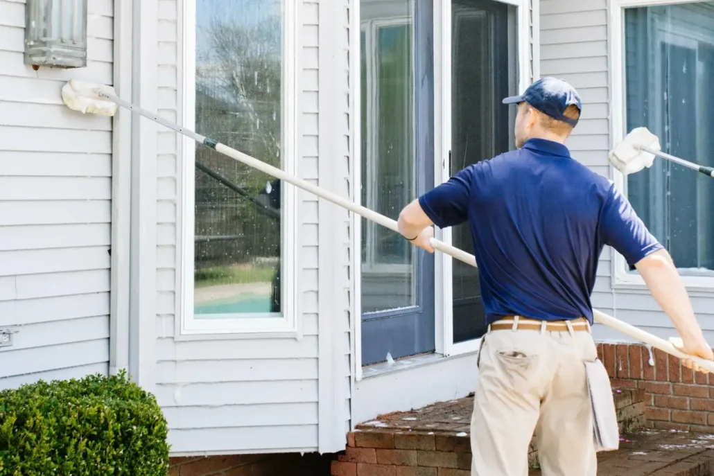 An Employee of P&D Power Washing Cleans a Home's Windows in Mahoning Valley.