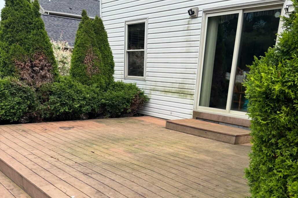 A Wooden Deck with Organic Growth on it Attached to a Canfield Home.